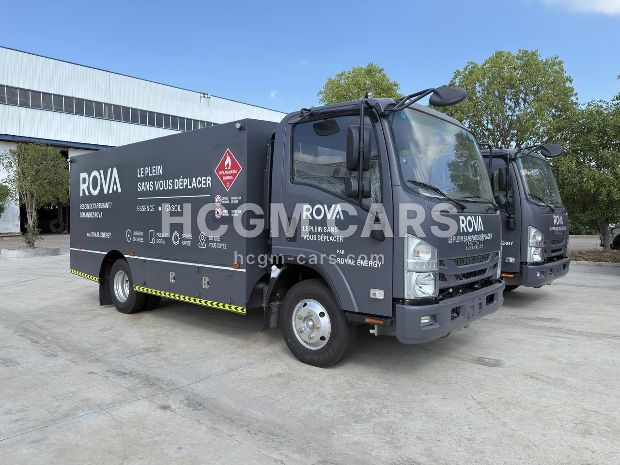Isuzu twin-compartment fuel delivery truck in a customer's dark grey livery, front three-quarter view
