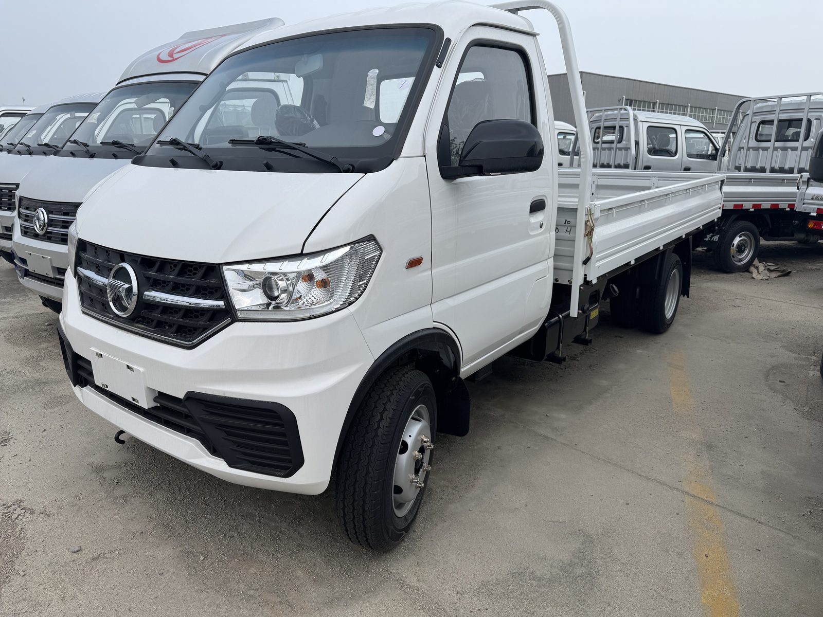KAMA 4x2 petrol mini truck in white with dropside bed, front three-quarter view