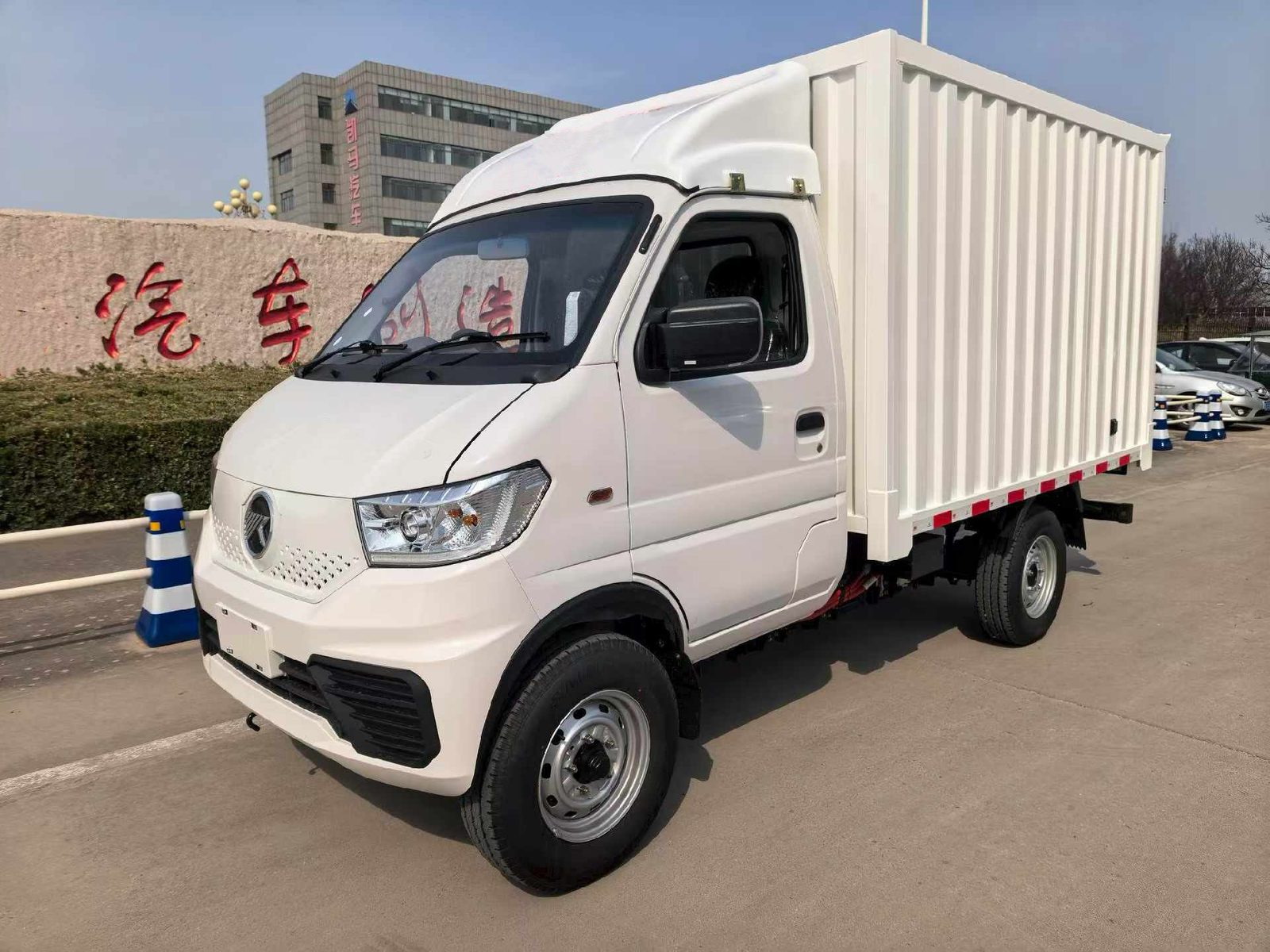 KAMA EW1 electric mini box truck in white, front three-quarter view